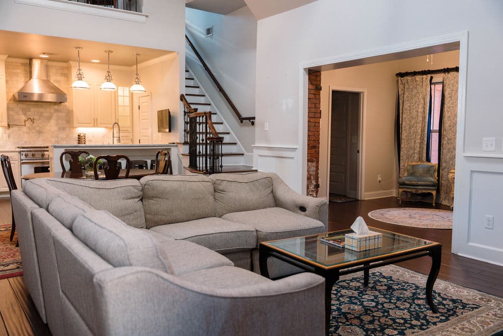 Interior layout showing the seamless flow between the comfortable lounge area, the eat-in kitchen with breakfast bar, and the private reading nook.